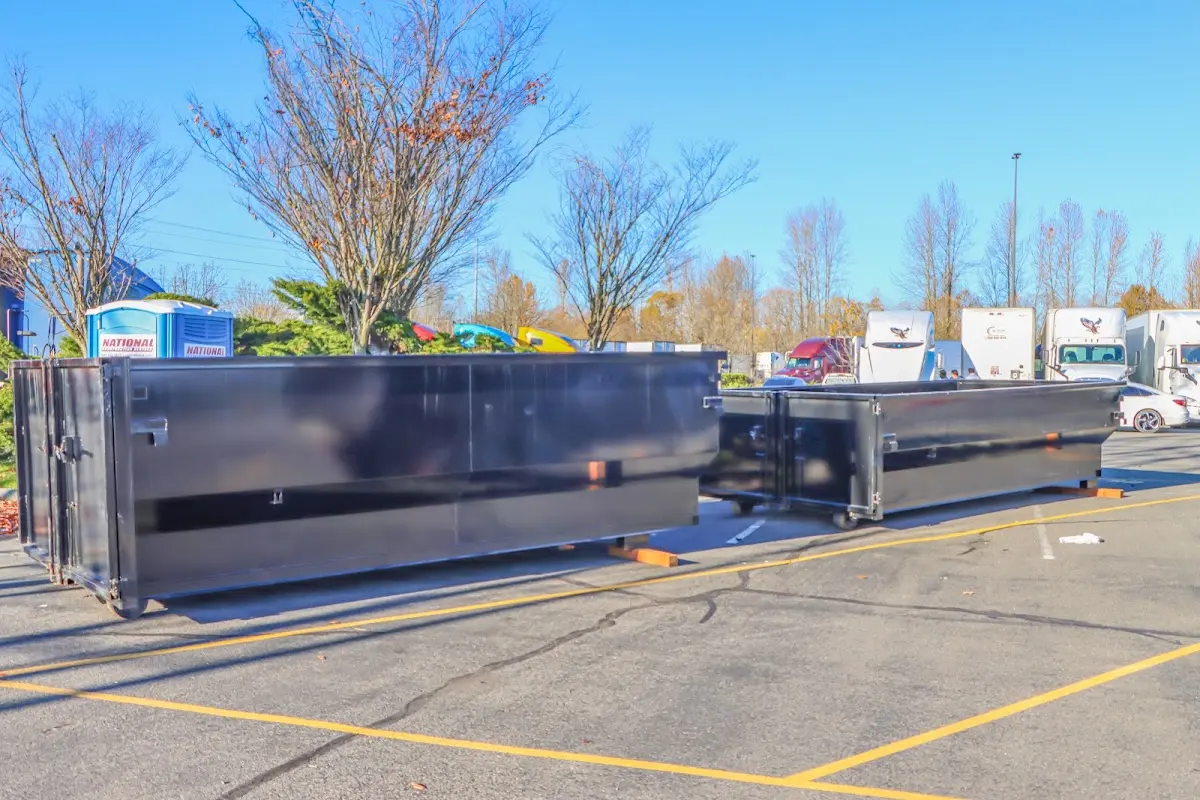 Professional dumpster rental service with roll-off container on residential driveway in Aiea